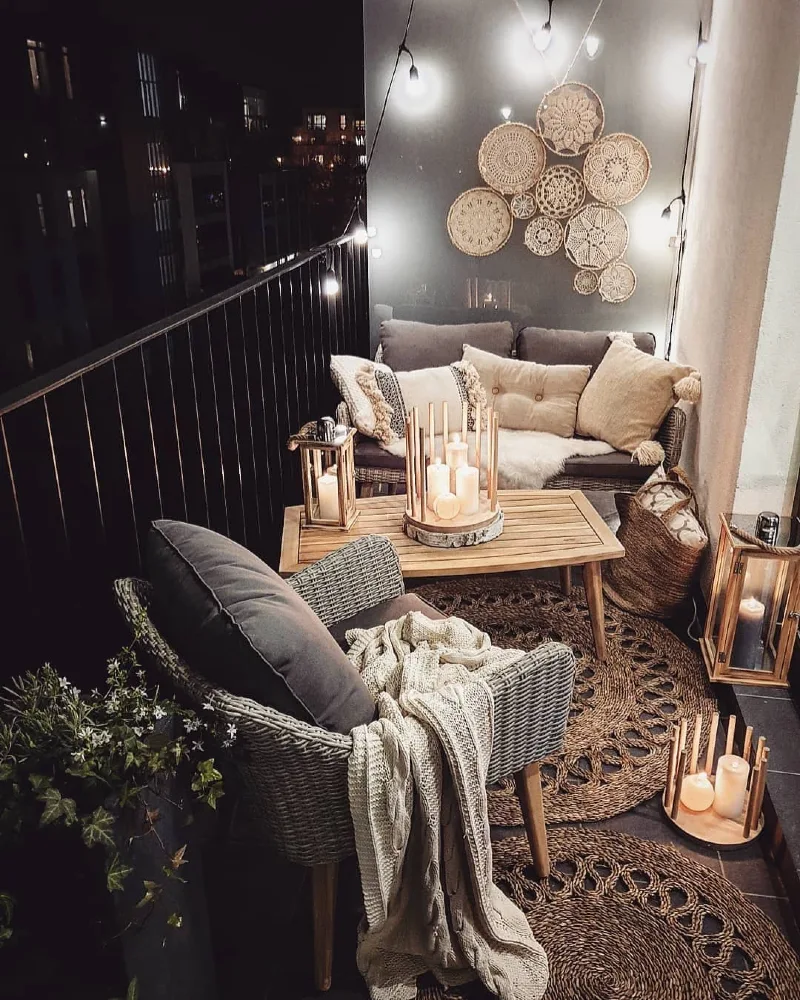 19. Night Balcony Lounge with Wicker Seating, Candle Lanterns, and Woven Wall Baskets