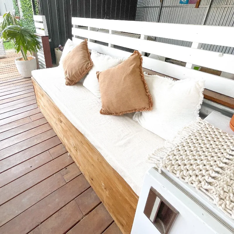 19. White Slatted Back Porch Daybed with Tan Pillows and Chunky Knit Throw