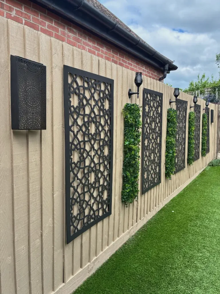 2. Beige Fence with Black Lattice Panels, Solar Lanterns, and Green Wall Strips