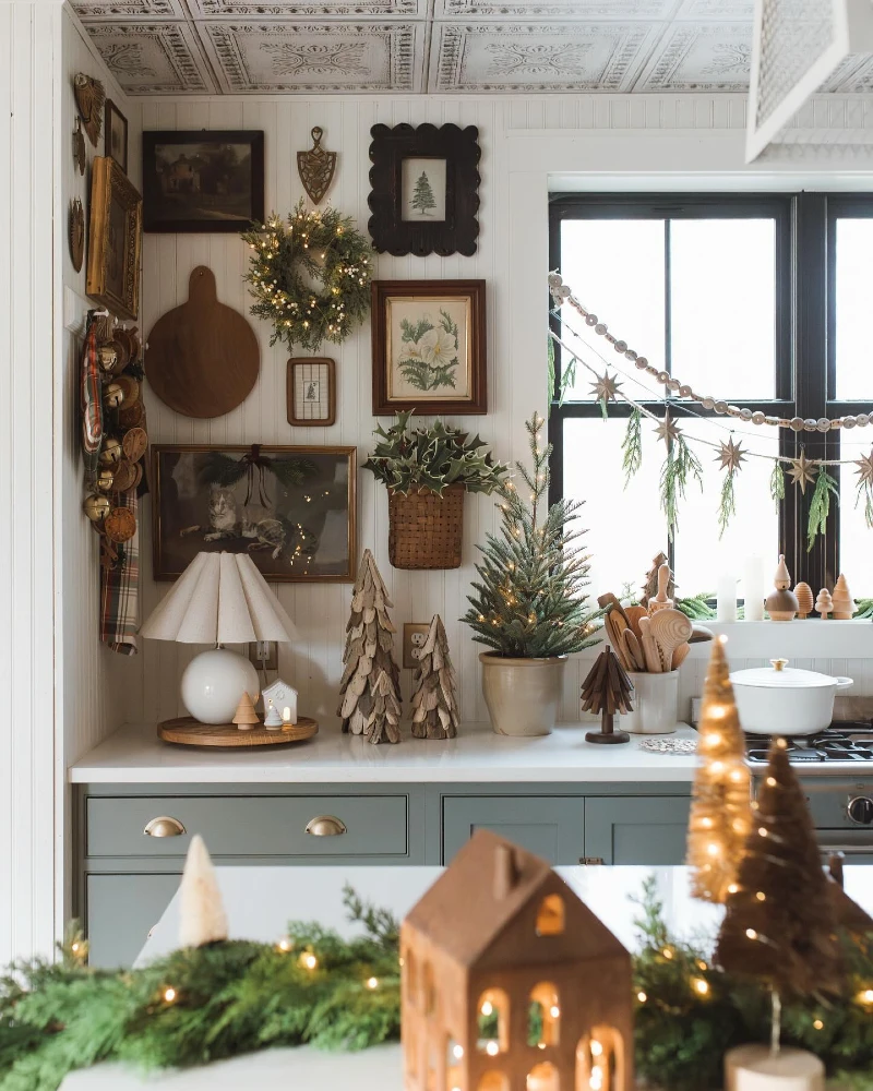 2. Cottage Kitchen Gallery Wall with Lit Wreath and Wooden Trees