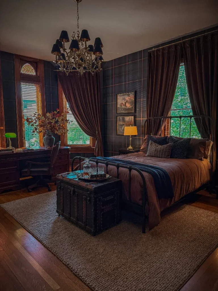 2. Dark Plaid Bedroom with Iron Bed, Velvet Drapes, and Steamer Trunk