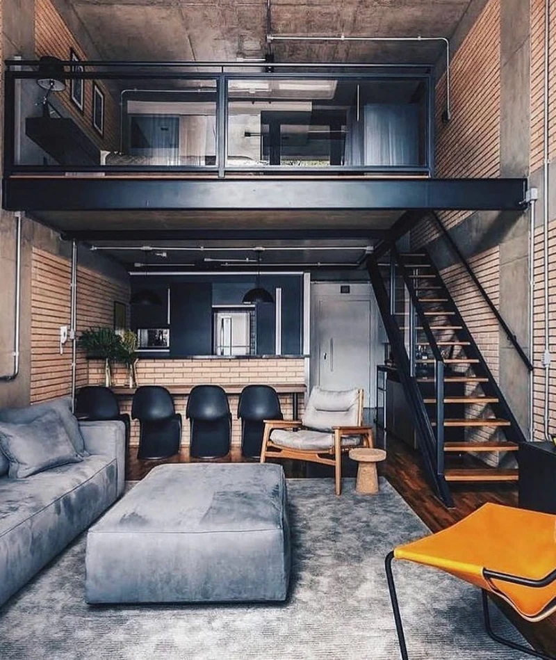 2. Glass Loft Mezzanine with Gray Sofa, Black Bar Chairs, and Orange Sling Seat