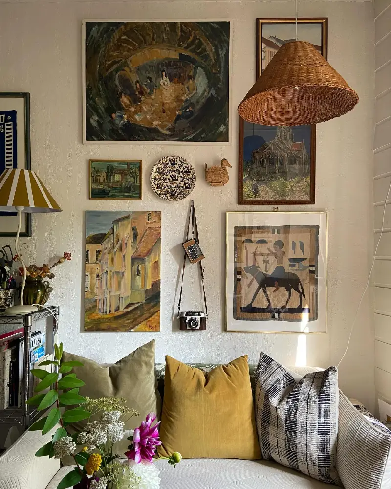 2. Layered Vintage Art Wall Above Sofa with Woven Pendant Light