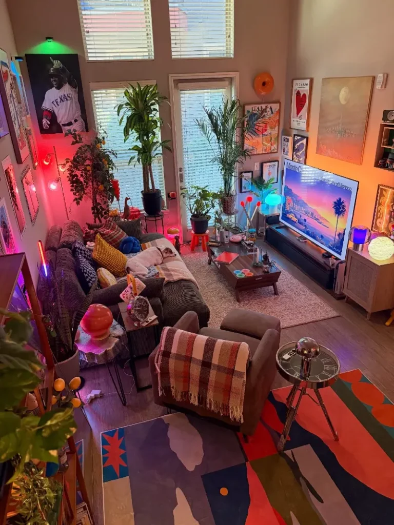 2. Loft Living Room with Neon Lamps, Tall Plants, and Graphic Rugs