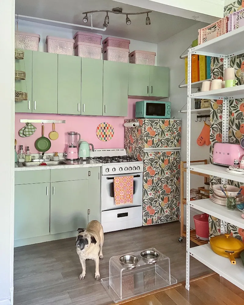 2. Mint Green Cabinets with Pink Accent Wall and Open Storage Styling