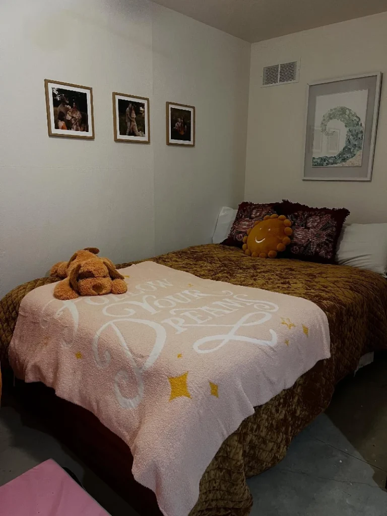 2. Warm Quilted Bed with Pink Dream Blanket and Framed Family Photos