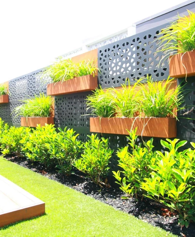 20. Charcoal Cutout Fence Panels with Cedar Planter Boxes and Lime Green Grasses