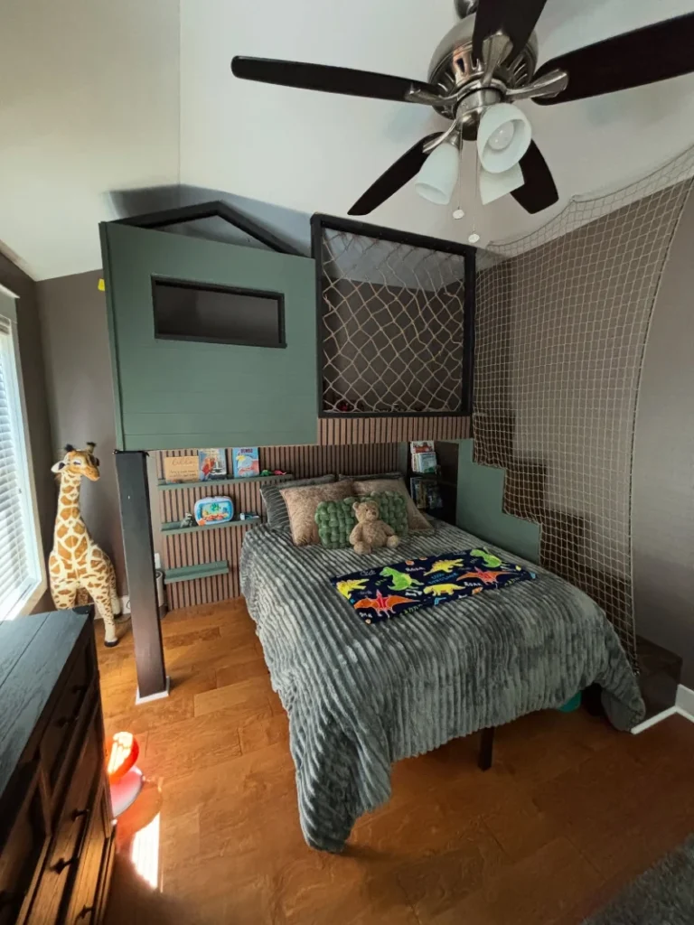 20. Green Playhouse Bed Frame with Net Wall, Built In Shelves, and Ribbed Gray Bedding