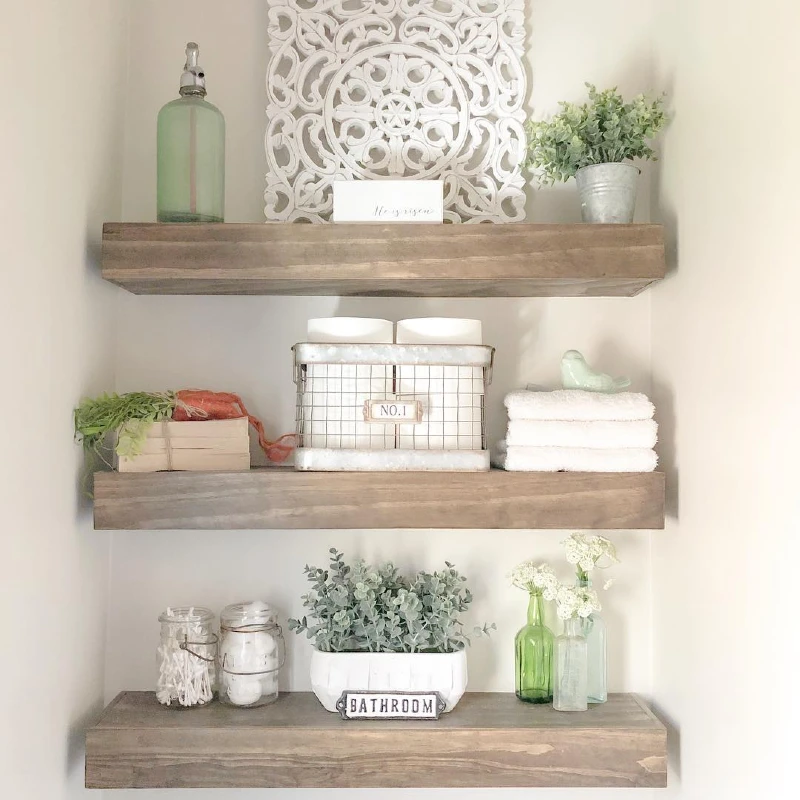 3. Bathroom Alcove Shelves with Folded Towels, Green Glass, and Soft Eucalyptus