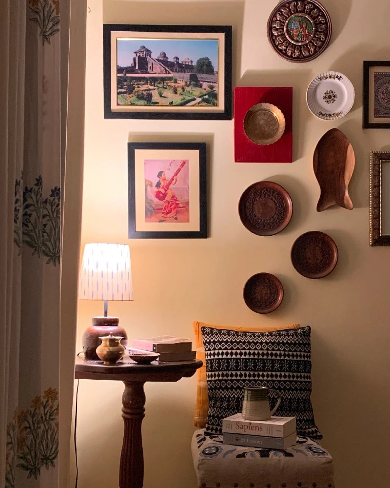 3. Eclectic Plate Wall with Framed Art and Warm Side Table Glow