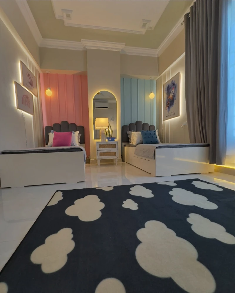 3. Twin Beds with Soft Wall Panels, Glow Mirror, and Cloud Rug
