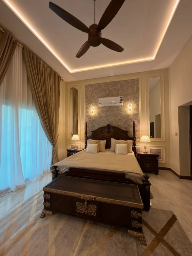 4. Carved Dark Wood Bed with Paneled Accent Wall and Heavy Gold Drapes