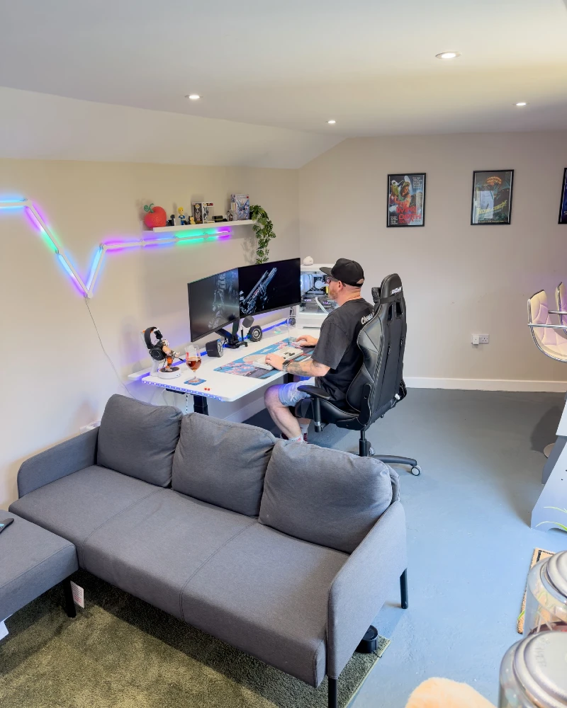 4. Gray Sofa Gaming Room with Dual Monitors and RGB Wall Lights