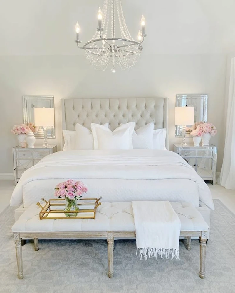 4. Mirrored Nightstands with Tufted White Bed and Crystal Chandelier