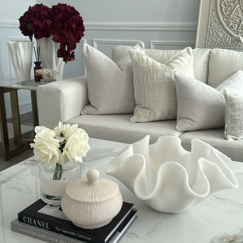 4. Ruffled White Bowl with Ribbed Jar and Cream Sofa Pillows