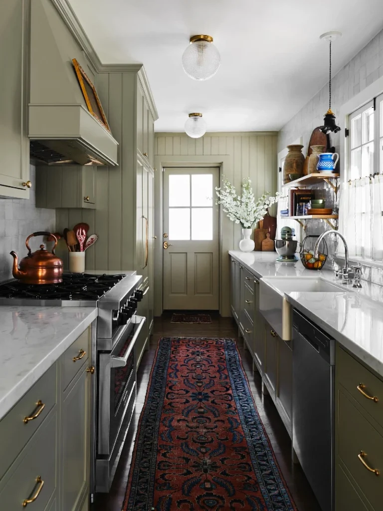 4. Sage Green Galley Kitchen with Brass Pulls, Marble Counters, and a Persian Runner