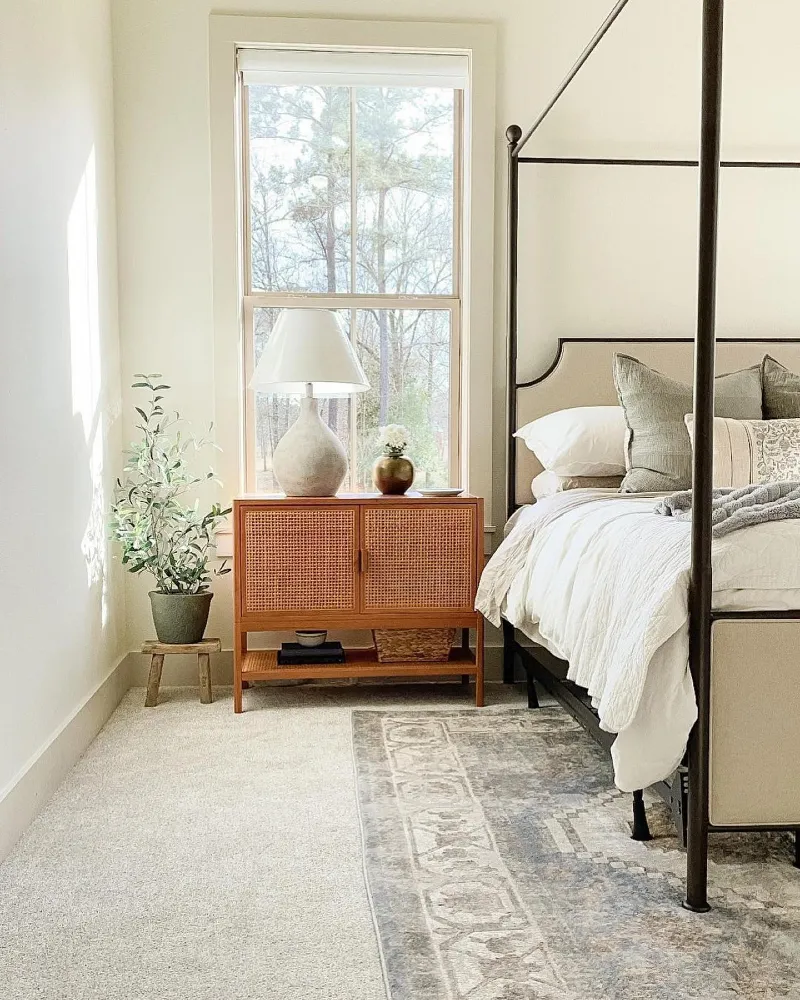 4. Soft Neutral Bedroom with Half-Layered Pattern Rug Over Rental Carpet