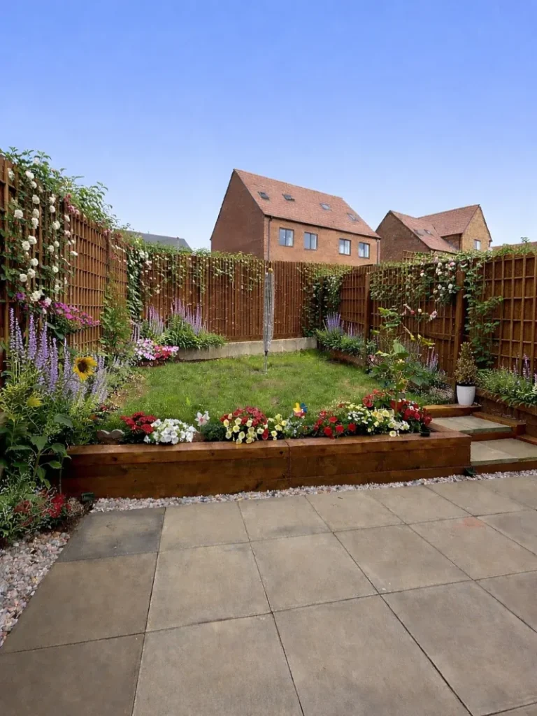 4. Timber Fence with Climbing Roses, Lavender Borders, and Raised Flower Beds