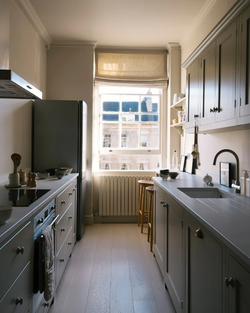 5. Soft Grey Galley Kitchen with Tall Sash Window and Linen Roman Shade