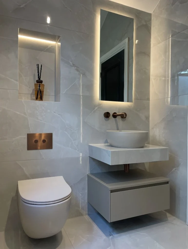6. Glossy Marble Walls with Floating Gray Vanity