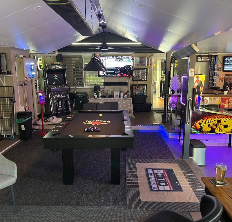 6. Pool Table Lounge with Arcade Cabinet, Neon Signs, and Pinball Corner