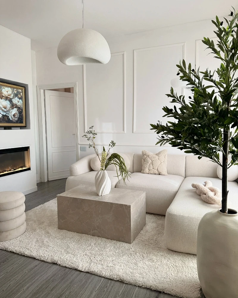 7. Cream Sectional with Stone Cube Table and Oversized Olive Tree