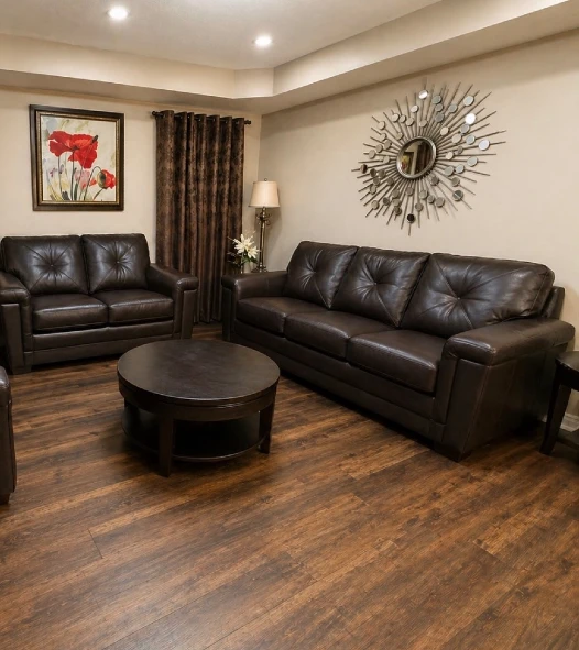7. Dark Brown Leather Seating Set with Round Wood Coffee Table and Warm Wood Floors