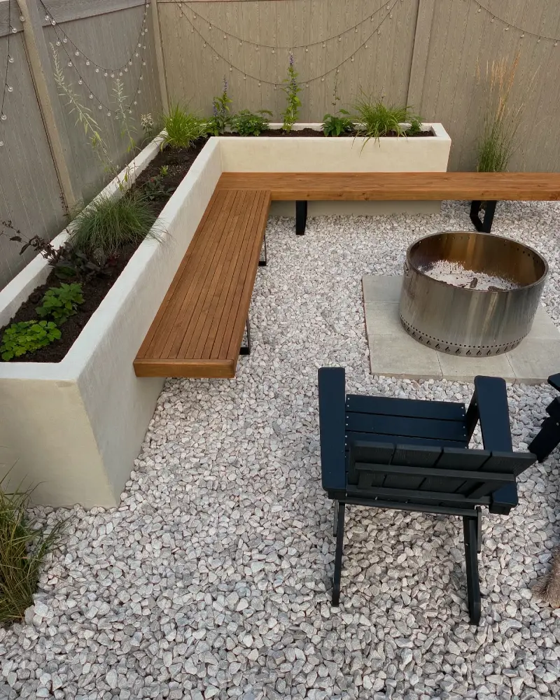 7. Floating Wood Benches Beside Raised Planters and a Steel Fire Ring