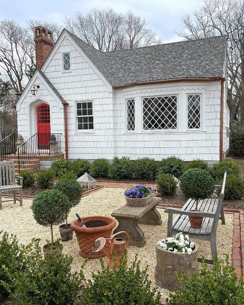 7. Gravel Courtyard Garden with Clipped Topiary, Brick Edging, and Weathered Benches