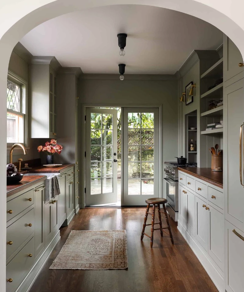 7. Sage Cabinet Galley Kitchen with Wood Counters and Garden French Doors