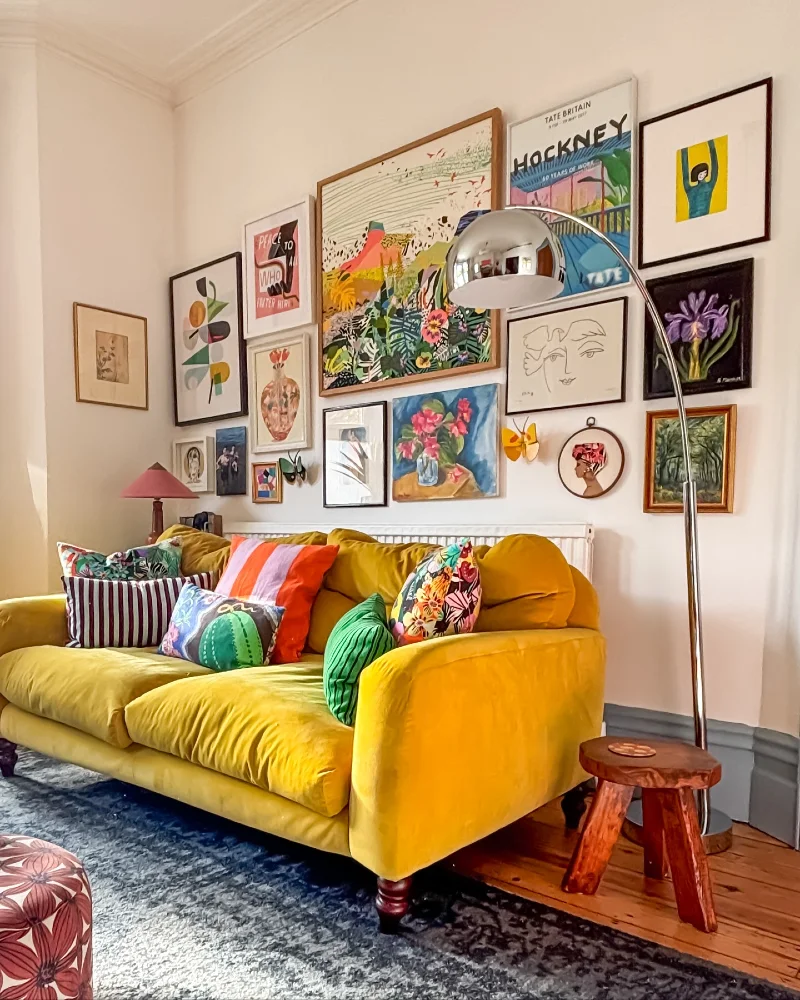 7. Vibrant Maximalist Gallery Wall Above Mustard Velvet Sofa with Eclectic Color Layers