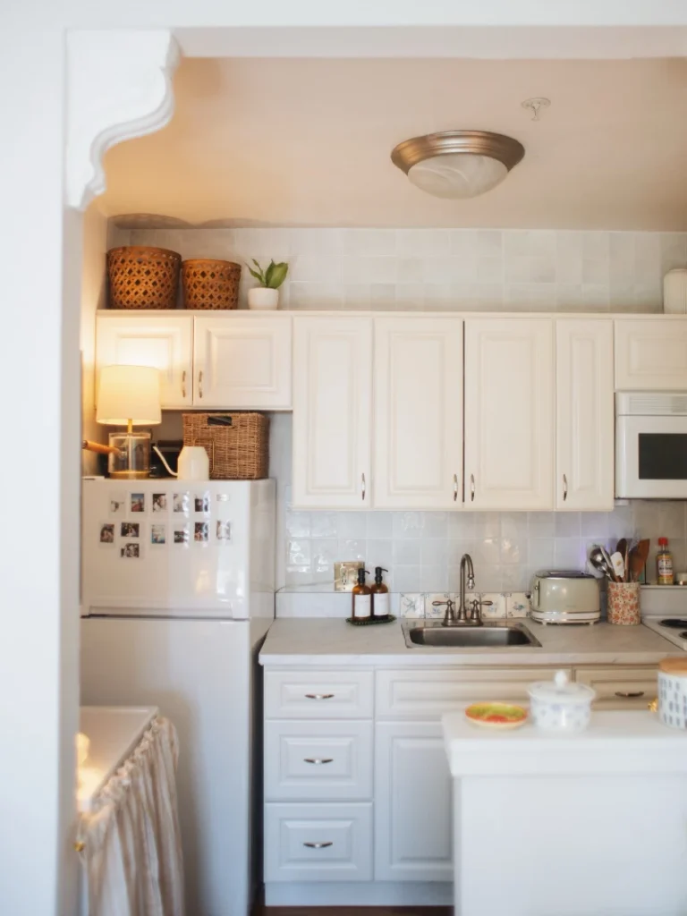 7. Warm White Cabinets with Woven Basket Storage and Fridge Memory Wall