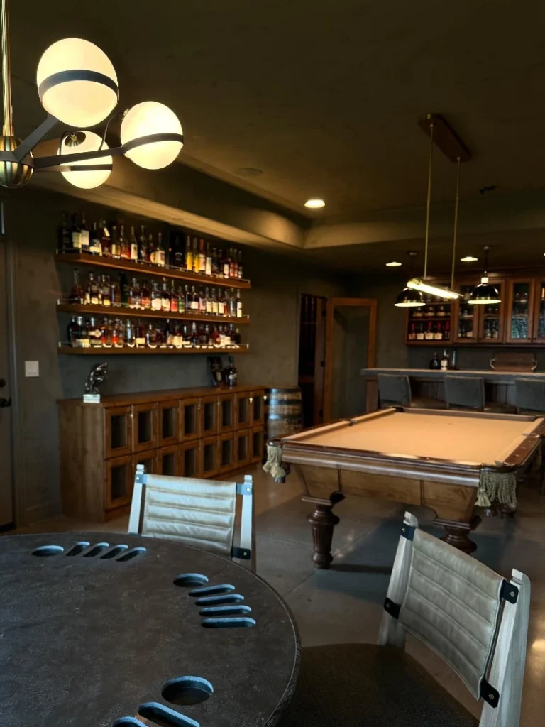 7. Whiskey Wall Bar with Pool Table, Globe Chandelier, and Lounge Seating