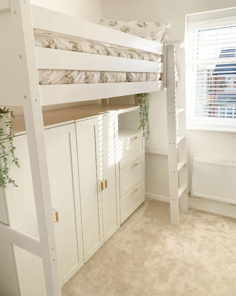 7. White Loft Bed with Hidden Wardrobe Doors, Drawer Stack, and Soft Greenery