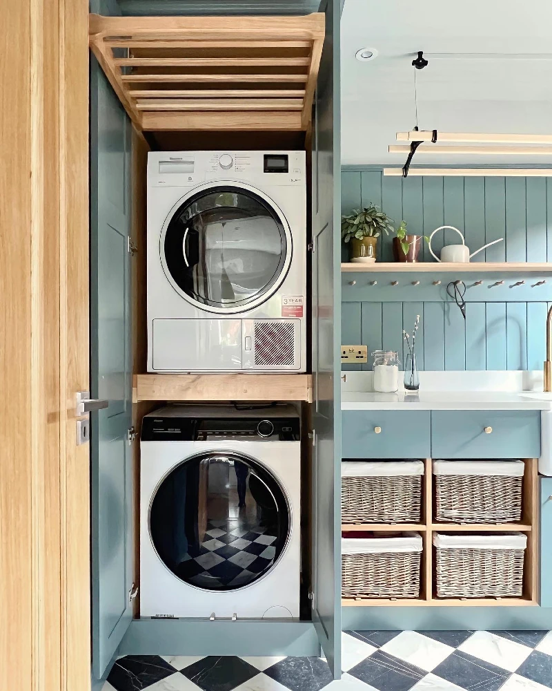 8. Blue Laundry Cabinet with Stacked Machines, Slatted Drying Rack, and Basket Cubbies
