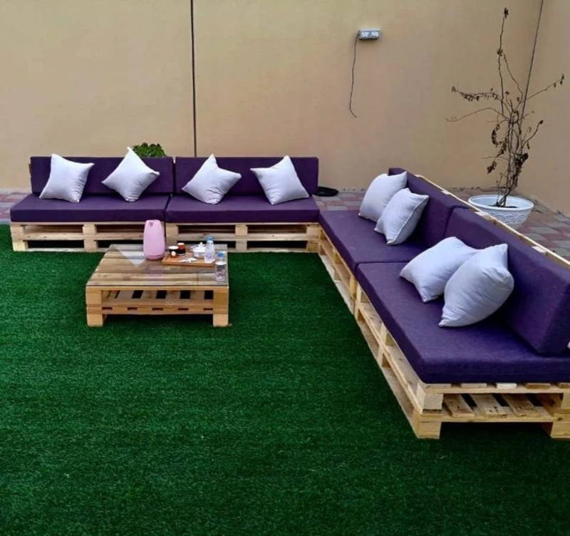 8. L-Shaped Pallet Sectional with Purple Cushions on Artificial Grass