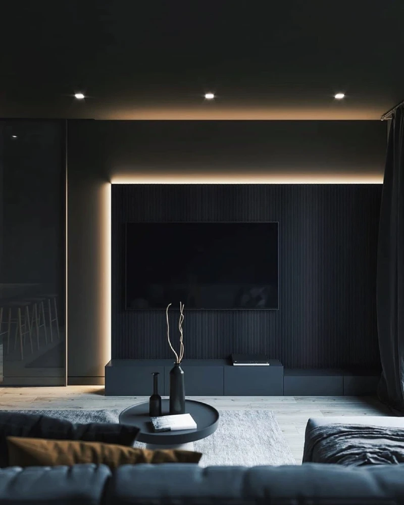 8. Ribbed Black Media Wall with Hidden Glow and Low Round Table
