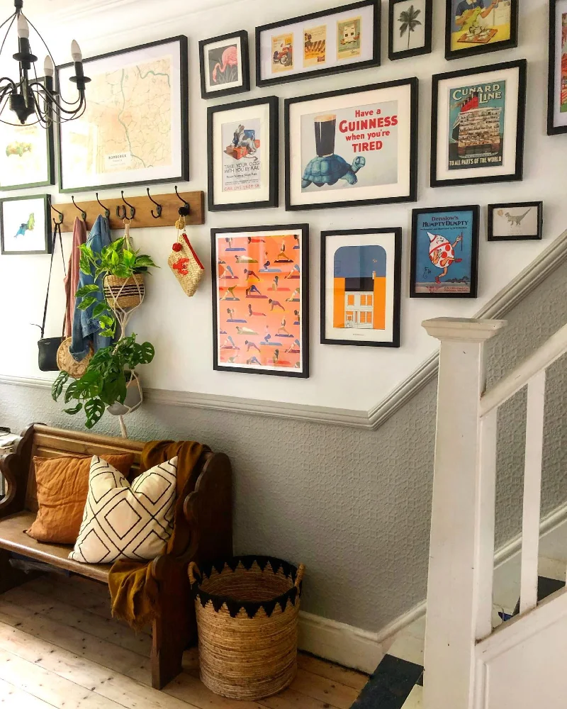 8. Staircase Gallery Wall with Travel Prints, Hooks, and Bench Styling Layer