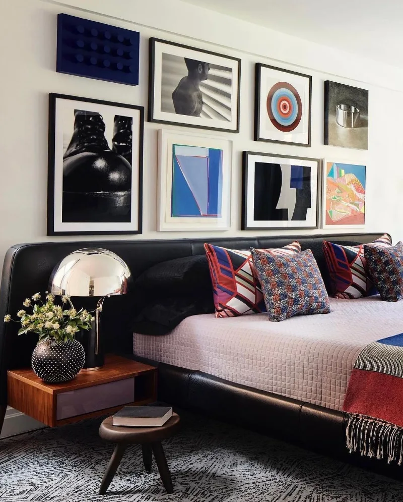 9. Bold Modern Gallery Wall Above Low Bed with High-Contrast Black Frames and Graphic Art Mix