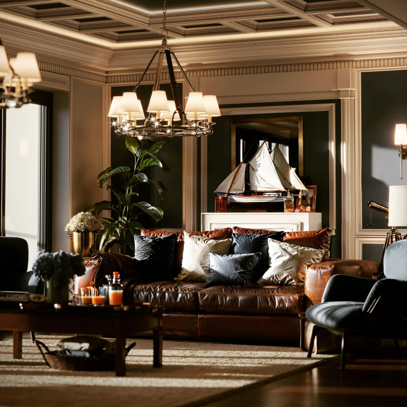 9. Brown Leather Sofa with Model Sailboat, Coffered Ceiling, and Deep Green Walls