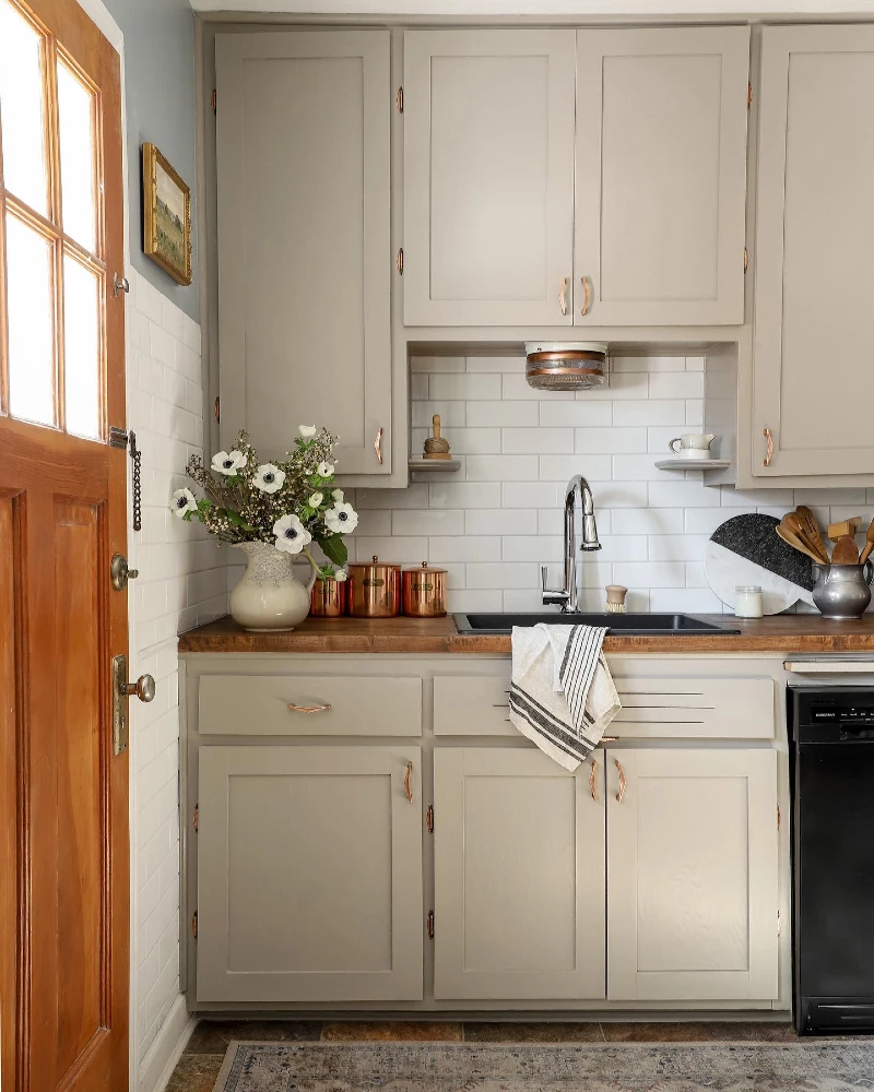 9. Taupe Shaker Cabinets with Copper Accents and Warm Wood Counter