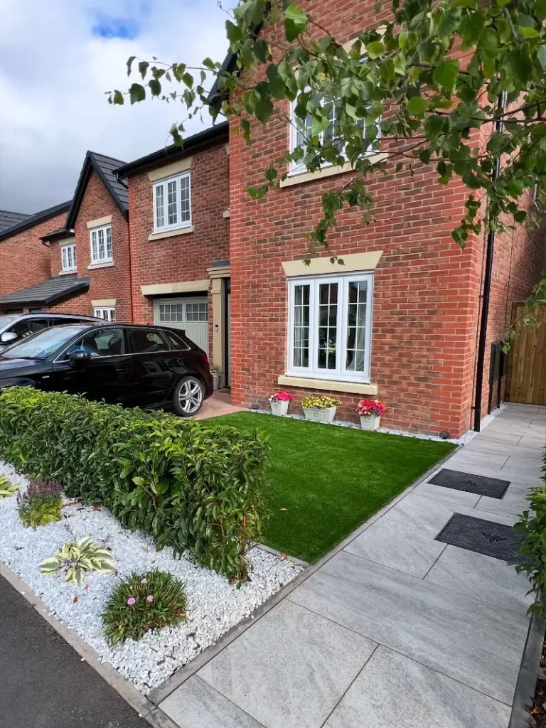 9. White Gravel Front Bed with Clipped Hedge, Faux Lawn, and Window Box Planters