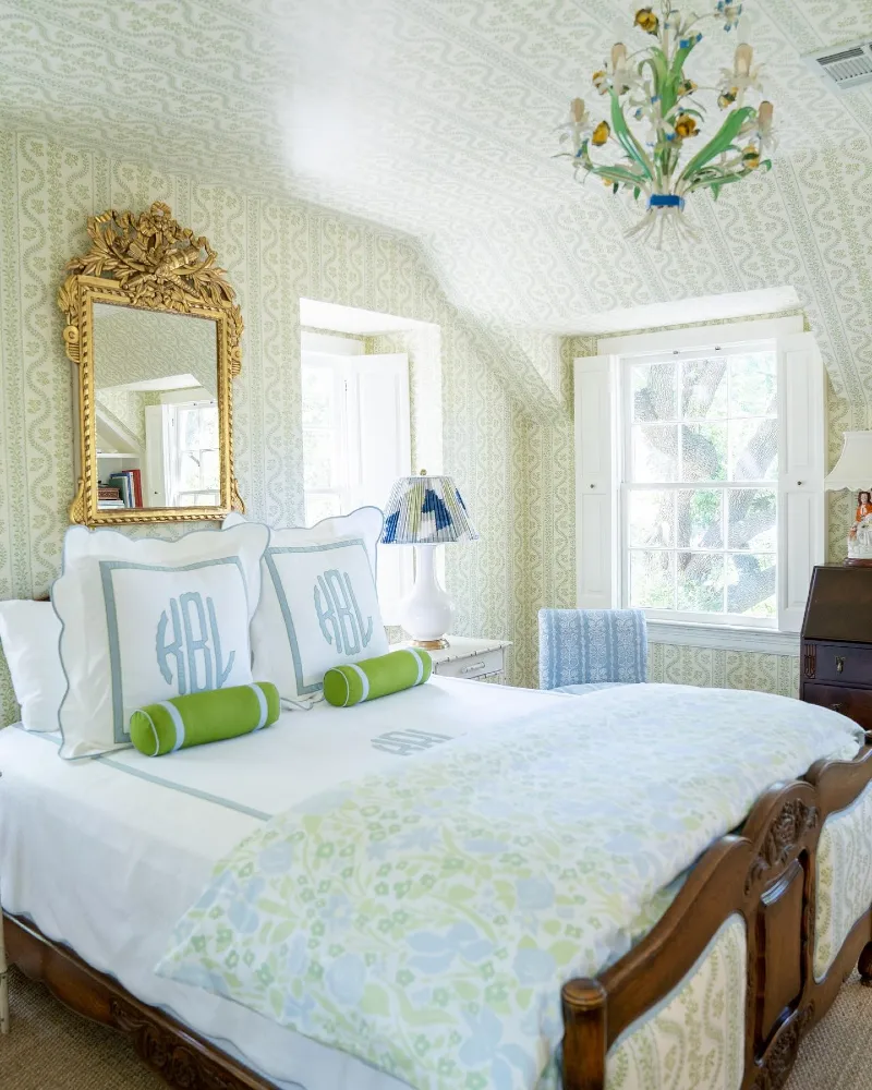 All-Over Green Vine Wallpaper with Monogrammed Pillows and Carved Gilt Mirror
