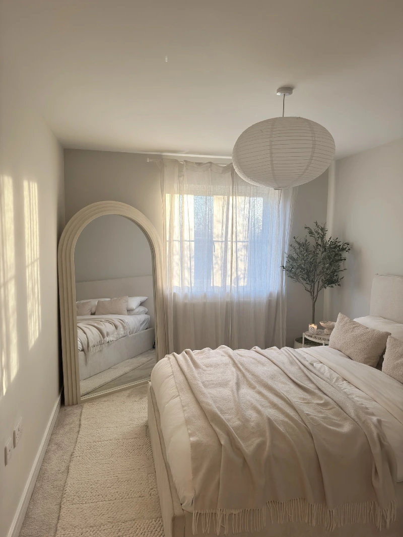 Arched Floor Mirror with Soft Linen Layers and Natural Light