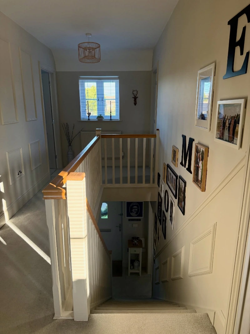 Beige Paneled Hallway with an Eclectic Photo Gallery and Bamboo Pendant Light