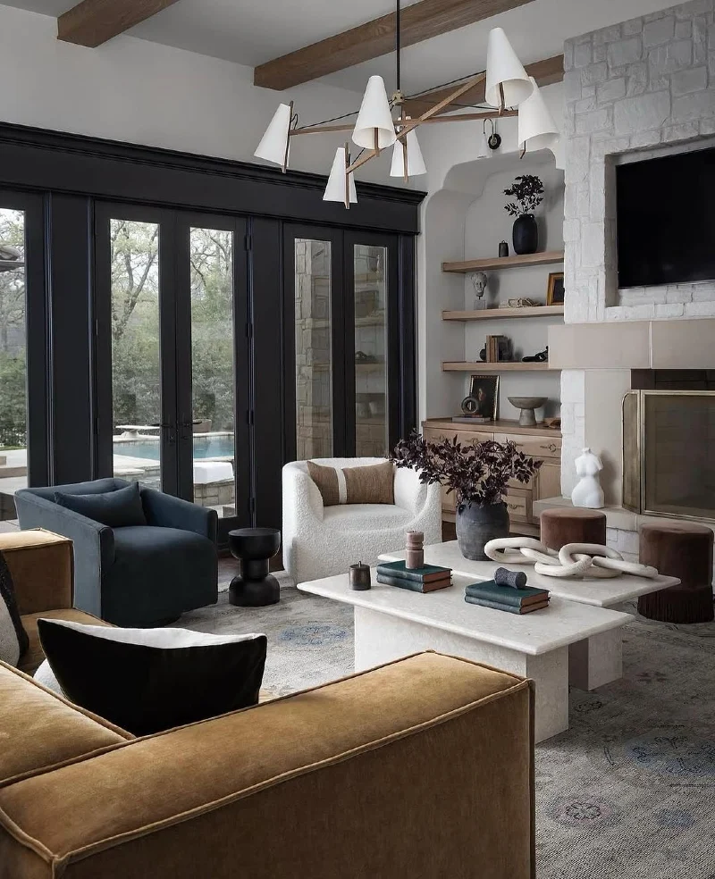 Black Glass Doors with White Stone Fireplace and Camel Velvet Sofa