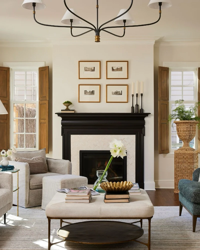 Black Mantel with Gold Framed Gallery Grid, Tall Candles, and Woven Plant Stand