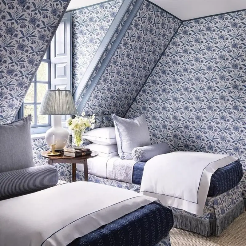 Blue Floral Wallpaper Enveloped Dormer with Matching Fringed Bed Skirts and Pleated Lamp