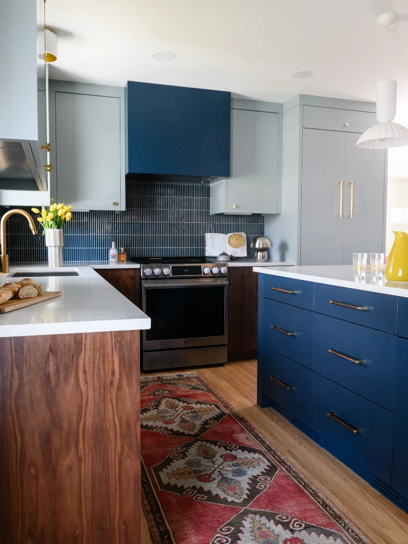 Blue Shaker Island Kitchen with Vertical Stripe Tile Backsplash and Warm Wood Accents