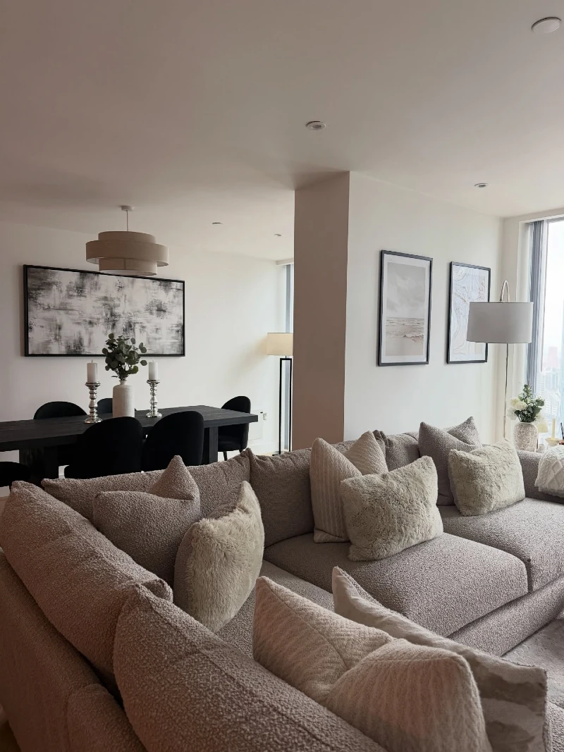 BouclΓ© Sectional Living Room with Monochrome Art and Soft Neutral Layers
